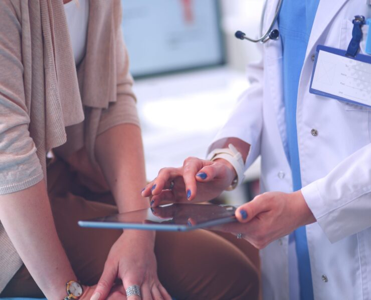Patient and doctor with tablet close up