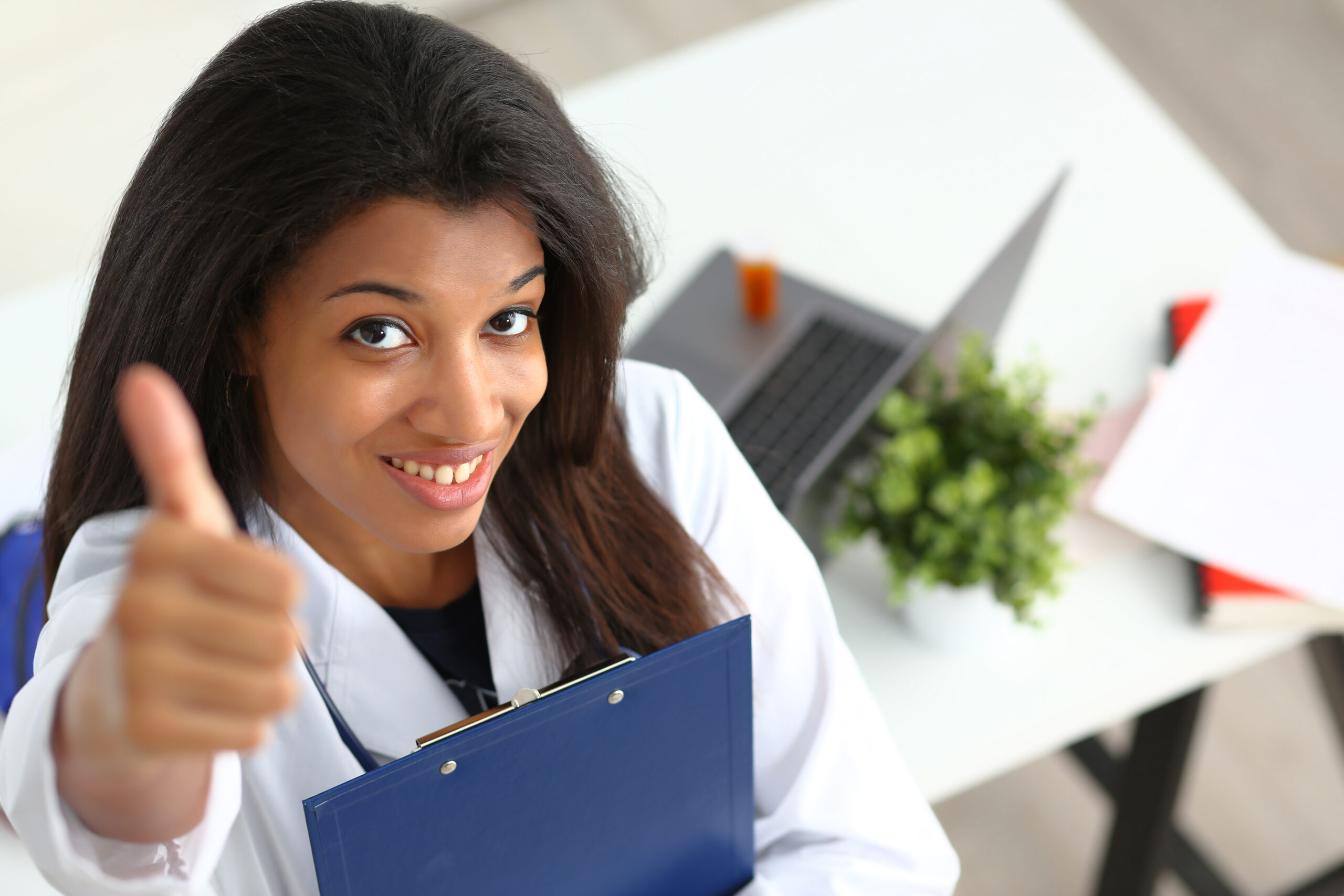 Female black clinician thumbs up