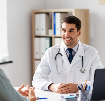 Male doctor smiling with patient